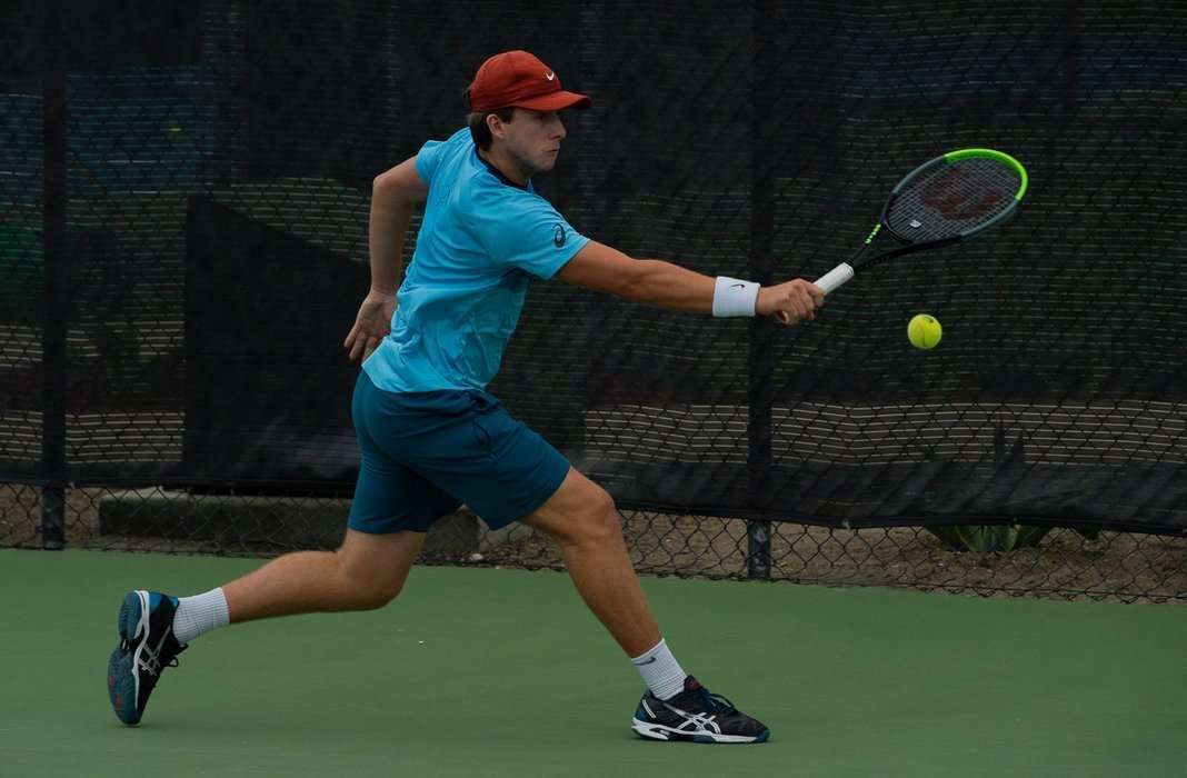 Brandon Holt returns the ball in matchplay during the 2020 Oracle ITA Masters by UTR
